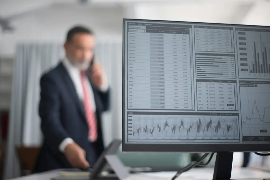 Business professional reviewing telecom analytics and operational performance dashboards.